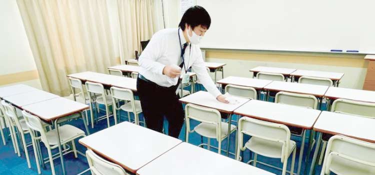 教室の除菌に取り組む講師